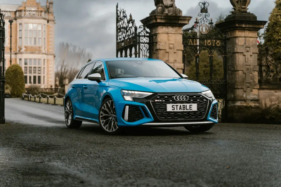 a blue car parked on a street